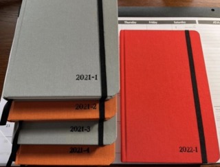 My 2021 journals alongside the first for 2022